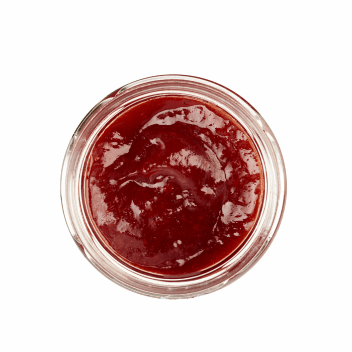 Lund Sylt marmelade Erdbeere- open Draufsicht auf ein Glasgefäß gefüllt mit roter Marmelade oder Soße auf weißem Hintergrund.